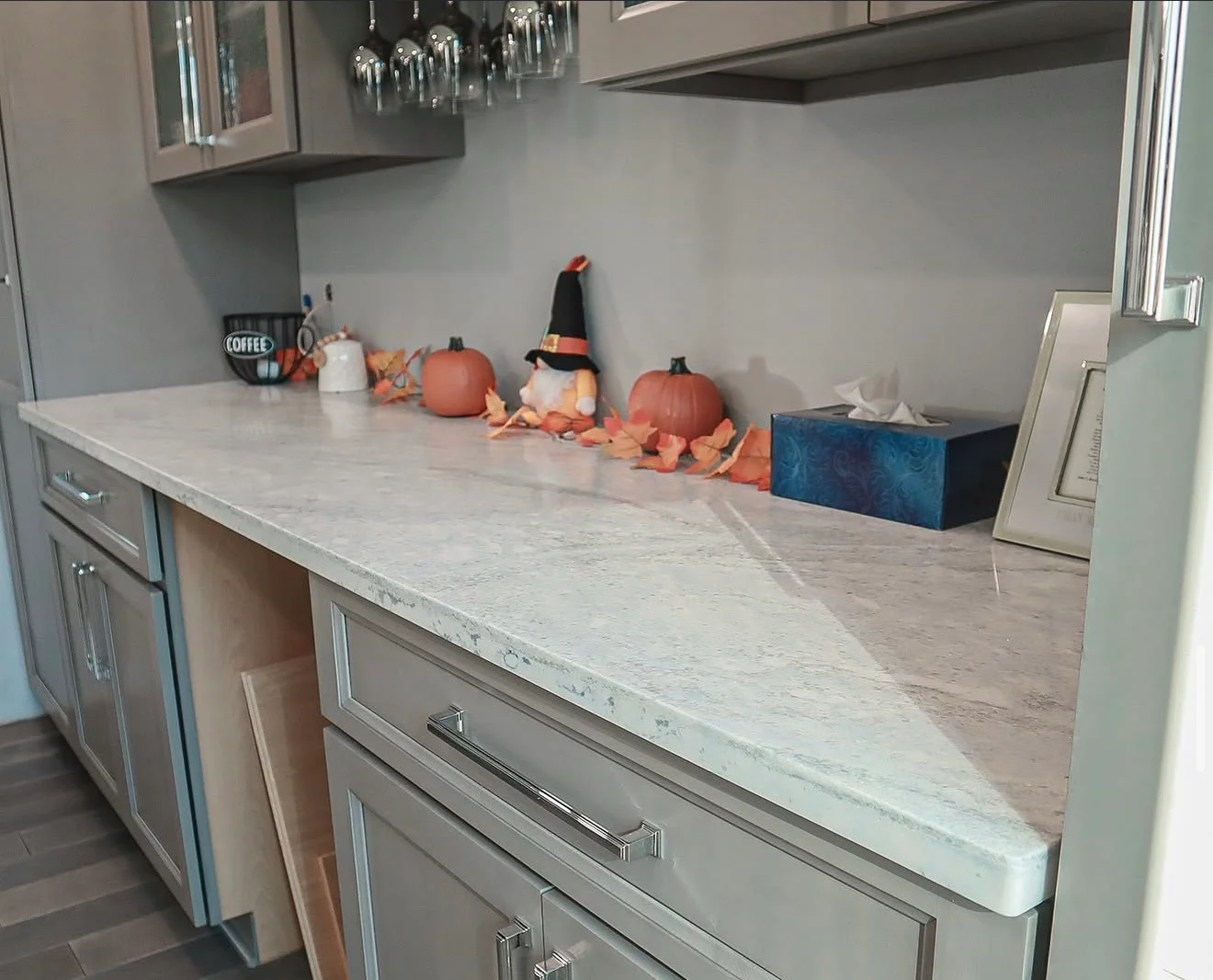 Light gray marble countertops with white veining on kitchen island and perimeter counters