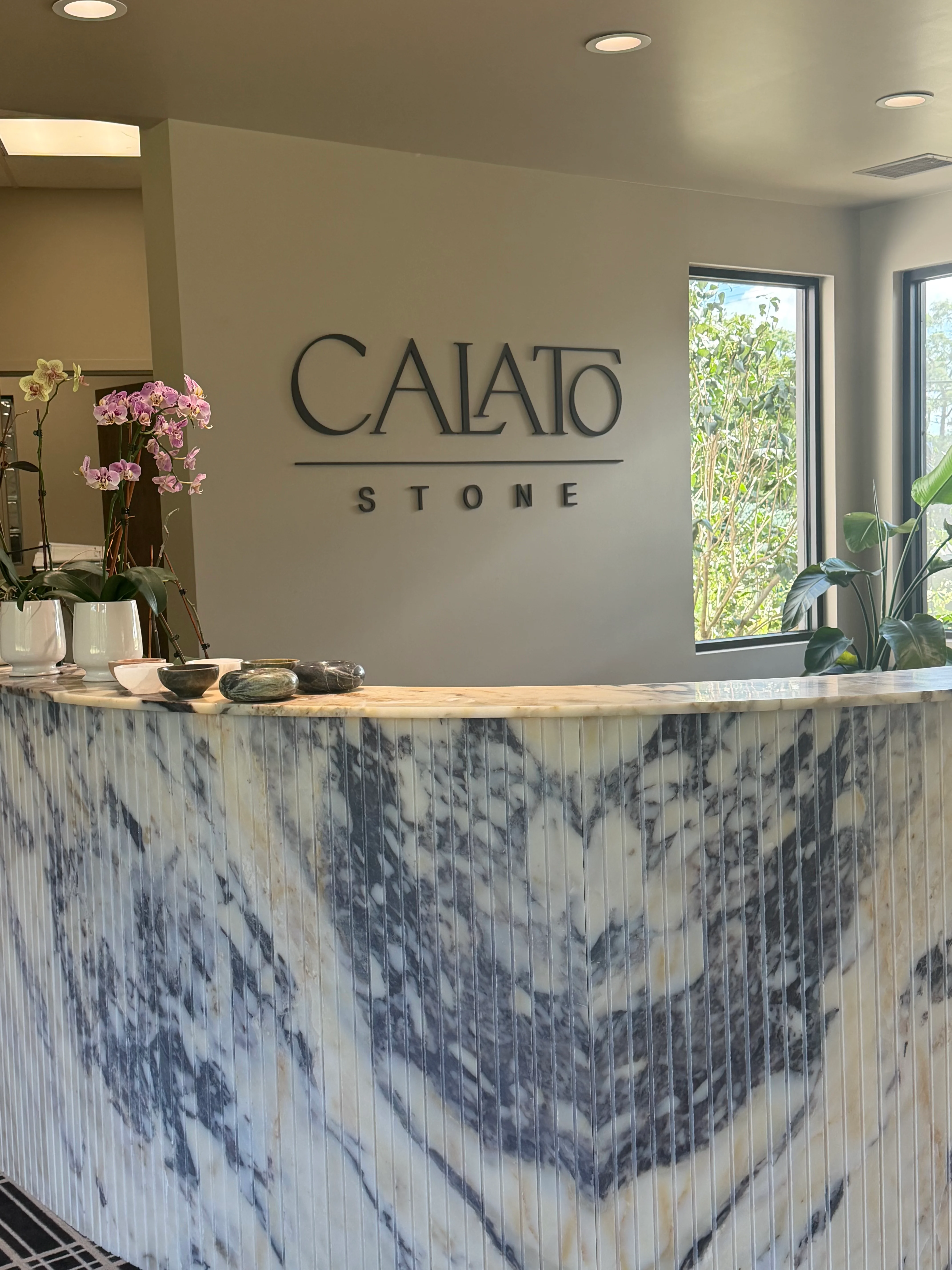 White and gray veined marble countertop with polished finish and integrated edge on reception desk