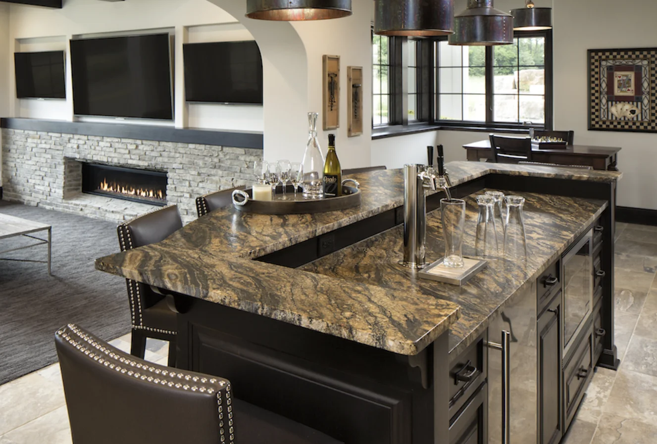 Freshly installed stone countertops in a commercial office break room in Clarence, NY, showing clean edge profiles and a polished surface finish. The counters run along two walls with an undermount sink and are ready for daily staff use.